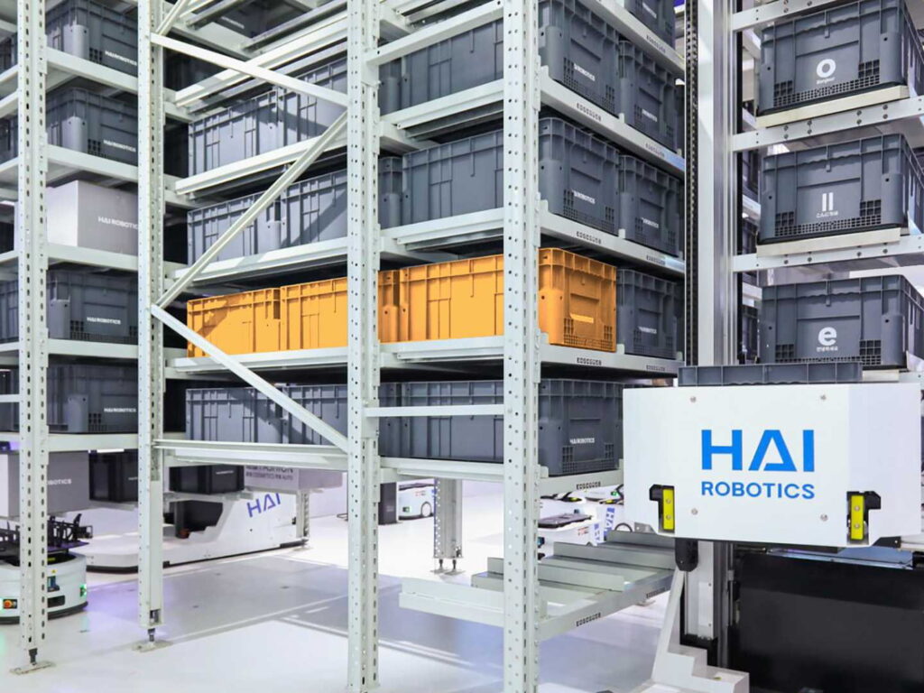 A HaiPick System 3 robot handling a tote in densely packed narrow-aisle racking